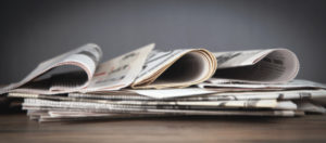 Newspapers on the wooden table.