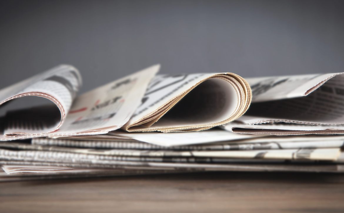 Newspapers on the wooden table.